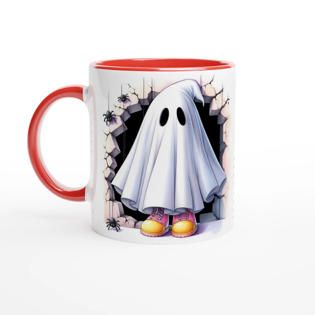 White mug with red handle and interior, featuring a sheet ghost in pink and yellow shoes, framed by cracked stone and spiders.