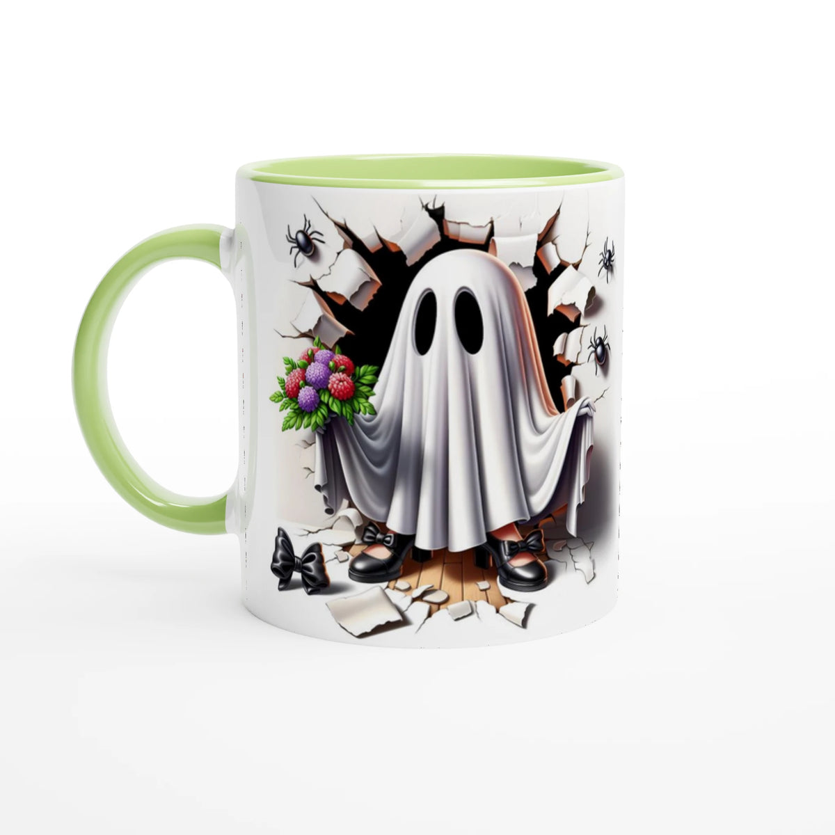 White mug with light green handle and interior, featuring a sheet ghost holding colorful flowers, with black shoes, cracked stone, and spiders.