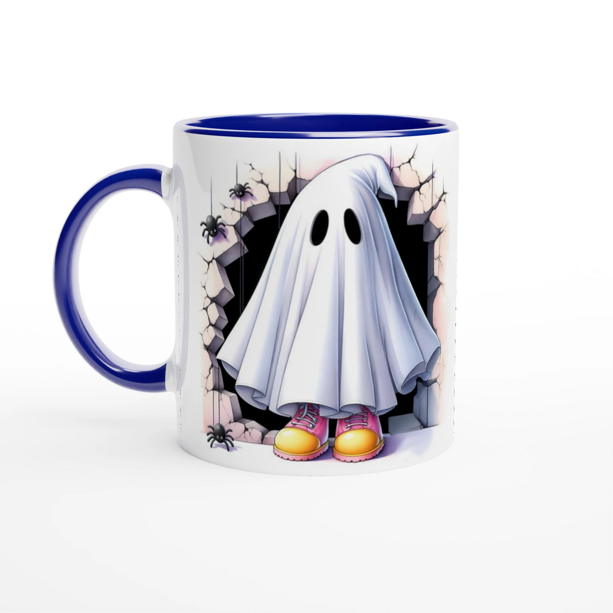White mug with blue handle and interior, featuring a sheet ghost in pink and yellow shoes, framed by cracked stone and spiders.