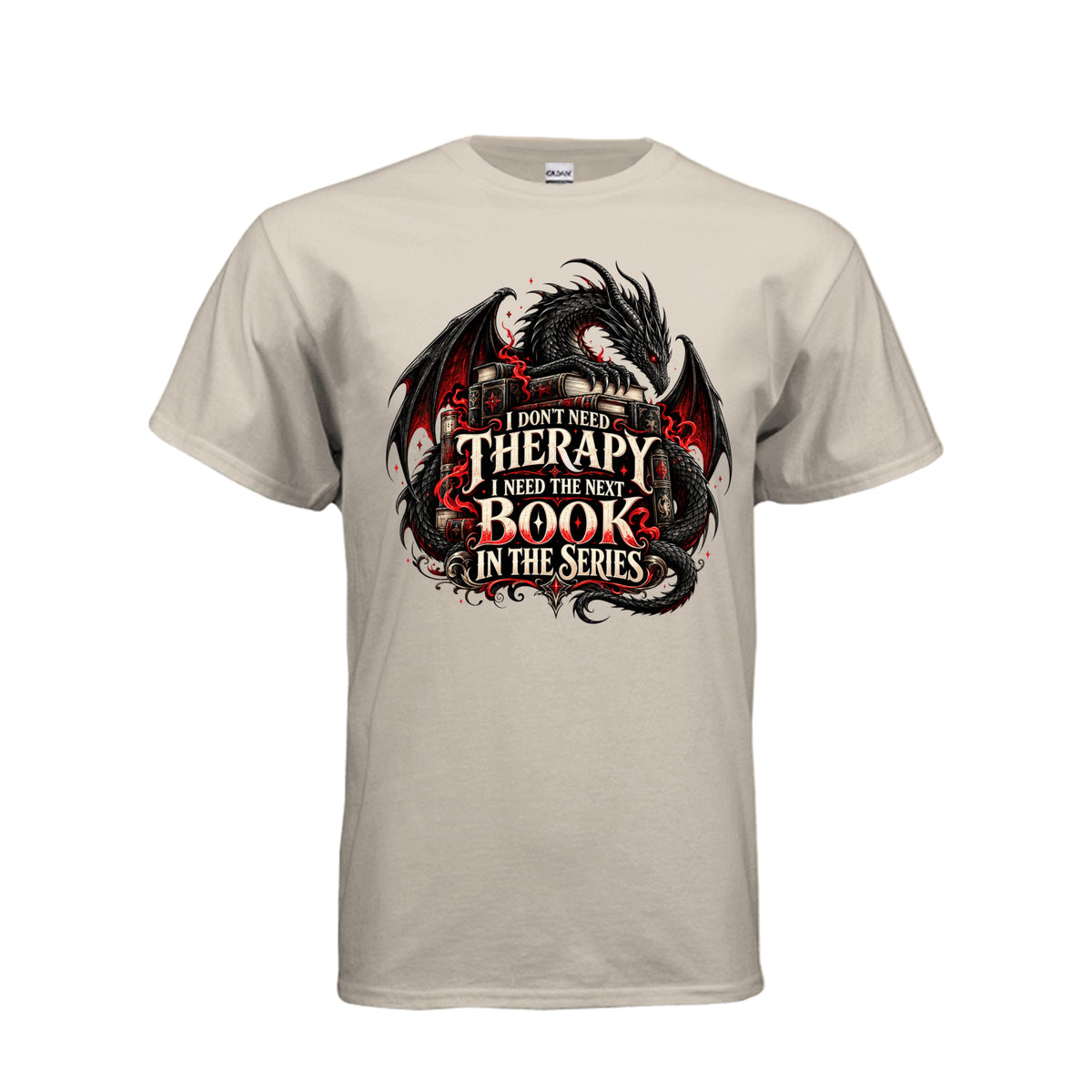 Front view of sand T-shirt featuring a black and red dragon, stacked books, and the quote “I don’t need therapy, I need the next book in the series.”