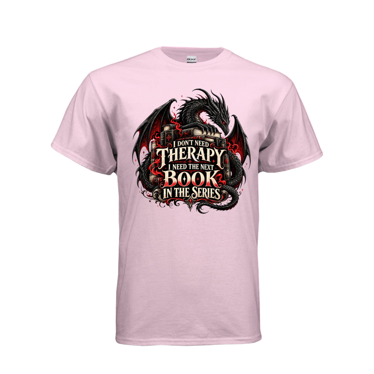 Front view of light pink T-shirt featuring a black and red dragon, stacked books, and the quote “I don’t need therapy, I need the next book in the series.”