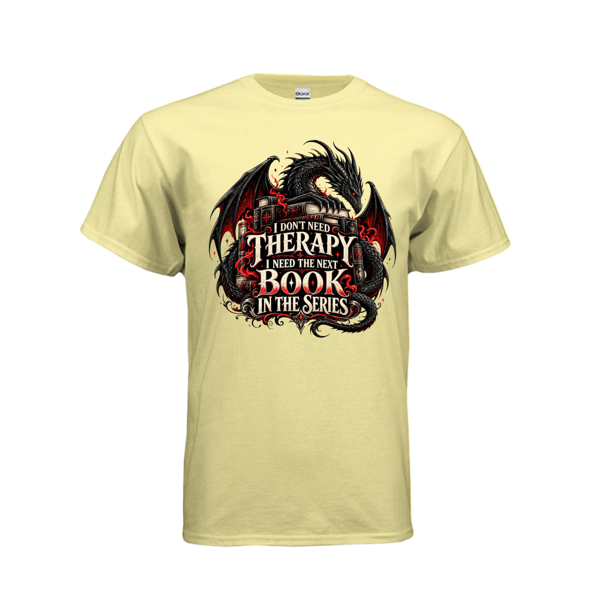 Front view of cornsilk T-shirt featuring a black and red dragon, stacked books, and the quote “I don’t need therapy, I need the next book in the series.”